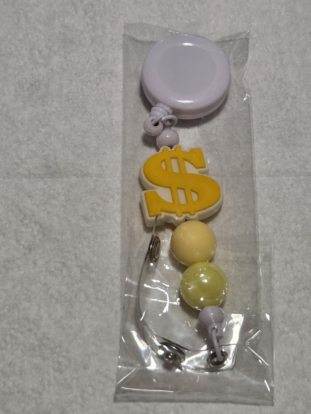 Yellow Dollar Sign Badge Reel with Beads